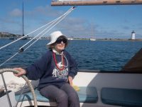 Phyllis Méras aboard Sea Chantey, a catboat owned by Mark Alan Lovewell. The sail on this day brought to mind a much smaller catboat, purchased around 1940. Photo by Mark Alan Lovewell.