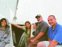 Ryan, Kate, Jim and Steve Humbert aboard Elfin, the Humbert's "tweener" boat, an O'day 22. Photo courtesy Pam Humbert