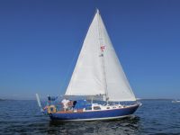 Photo courtesy Scott ThurstonThurston aboard his pretty Penny, which on more than one occasion he's sailed the last day of the year in Maine.