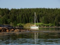 Photo by David BuckmanA boat at anchor in The Cows Yard off Head Harbor Island, Maine.