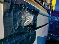 Photo courtesy Michael LongThe wine bottle and duct tape "fix," partial contents of the bottle displayed on the hull to leeward.