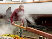 Foster takes plank out of steamer. Jimmy and Foy (behind the steam) are ready to take the plank.