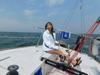 Newly minted girlfriend/sailor Diana diligently checks, while driving, mainsail trim aboard Student Driver, the author's J/24. Photo by Mark Barrett