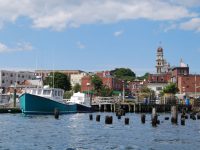 The commercial fishing vessel Miss Carla in Western Harbor, the spire of Gloucester City Hall in the background.