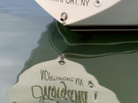 The stern of the author's boat is seen reflected in the waters of Port Jefferson Harbor. Photo by Pam Humbert