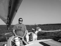 Gaylen steers while Tahoe keeps an eye out for any trouble to windward.