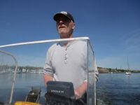 Photo by photographerAbove, he’s got the whole world in his hand. At right, the author navigates the All In around his farm. Inset: The work involves a lot of wading.