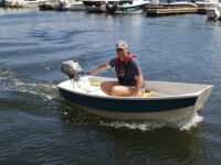 Photo by John GoldAbove, Chase motors the Points East Pram with a 2hp Honda outboard. At left, a comparison between the eight and 10-foot models of the dinghy.