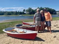 Photo by Alexandra BurkeDick, Gina and Chris with one red rowboat for each. On the beach in Onset, Mass.