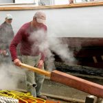 Foster takes plank out of steamer. Jimmy and Foy (behind the steam) are ready to take the plank.