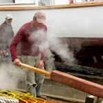 Foster takes plank out of steamer. Jimmy and Foy (behind the steam) are ready to take the plank.