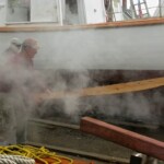 Foster and Jimmy are about to hand the plank to Foy who is behind the steam.