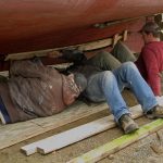 Jimmy adds the first screw to the plank.